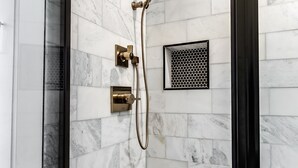 A shower with a glass door, a handheld showerhead, and a wall-mounted control panel. - Modern Luxe Apartment - Close to City Center (Richmond)