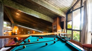 A pool table in a room with wooden beams and large windows. - Caloura 66 - Vacation Villa (Lagoa)