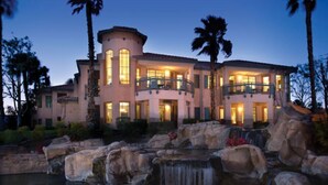 A large, multi-story building with a waterfall feature in front.