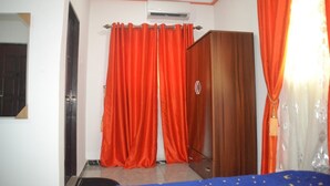 A room with a wardrobe, a bed, and red curtains. - Evaville Hotel N Lounge (Port Harcourt)