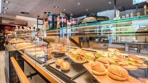 A buffet area with various food items and a modern interior design.