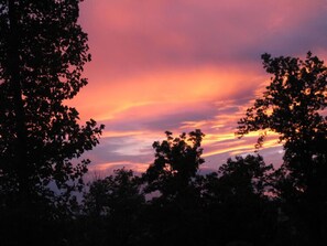 A sunset with a pink and purple sky, surrounded by trees. - Owl Be Back, 2 Bedrooms, Pool, Hot Tub, Fireplace, Sleeps 6 (Gatlinburg)