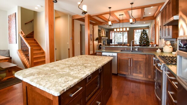 A spacious kitchen with wooden cabinets, granite countertops, and a central island. - Amazing Upgraded Chalet with Everything You Need and It's ALL Yours - No Suite (Silver Star Mountain)