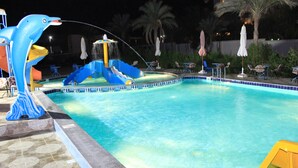 A swimming pool with a dolphin-shaped water feature and a slide. - 100 Night per year at Grand Blue Hotels (Cairo)