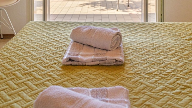 A room with a bed, a view of the sea, and a chair outside. - Rooms Sani - Double Room with Terrace and Sea View (S1) (Brela)