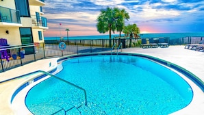 A swimming pool with a no diving sign, surrounded by lounge chairs and a view of the ocean. - Beach Front Condo with Endless Gulf Views!   (Panama City Beach)