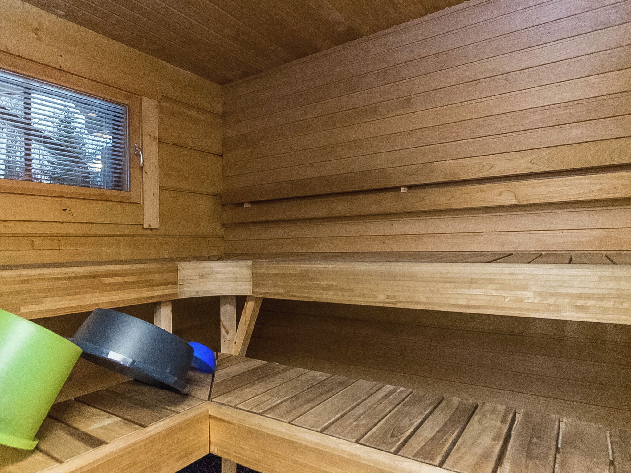 A sauna with wooden benches and a window.