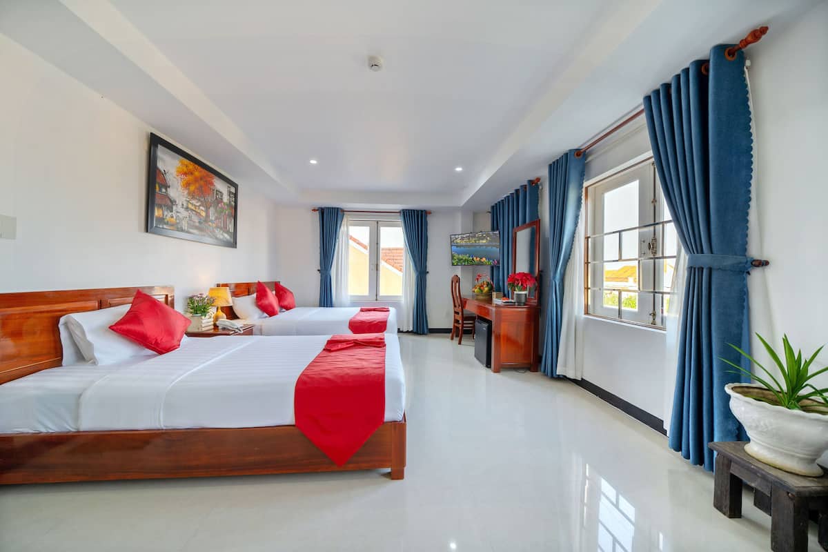 Deluxe Triple Room, City View | Minibar, in-room safe, desk, laptop workspace