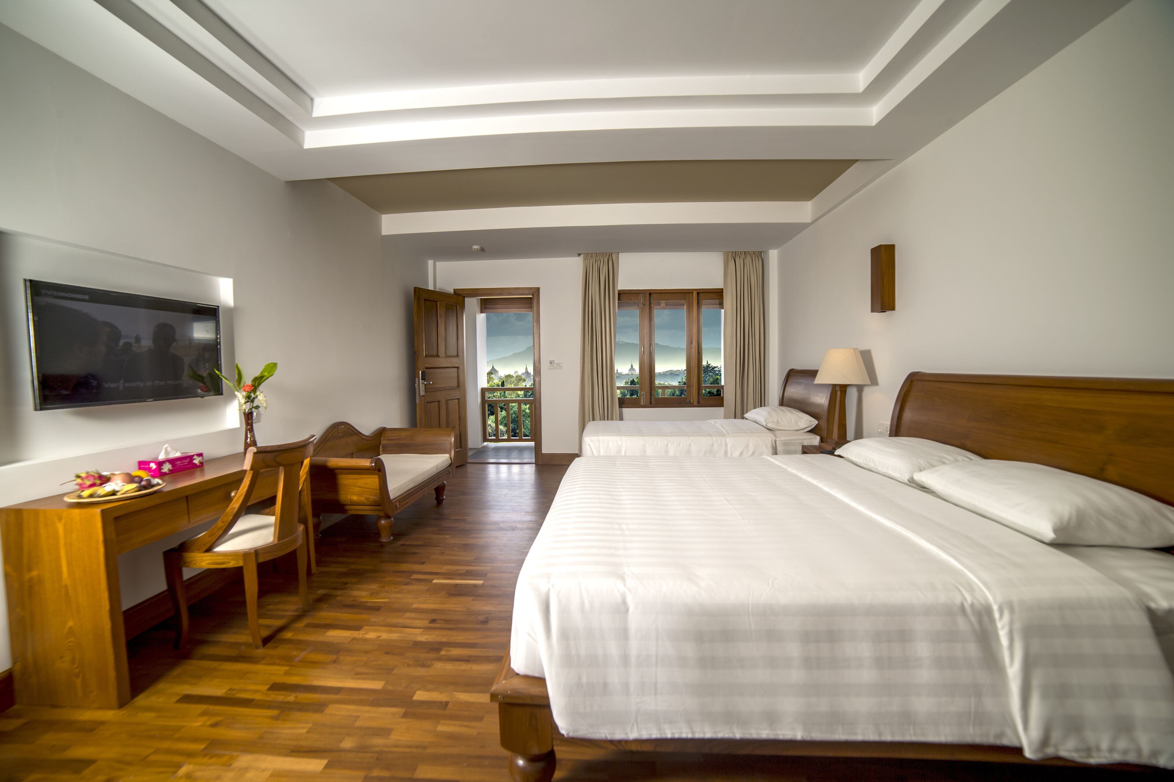 Deluxe Triple Room | Minibar, in-room safe, individually furnished, desk