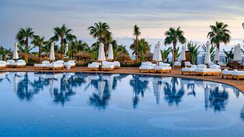 Indoor pool, outdoor pool, pool umbrellas, pool loungers