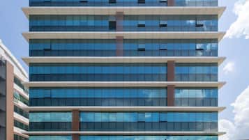 A multi-story building with a modern glass facade, featuring the signage "edimplaza 2" and "plaza hotel".