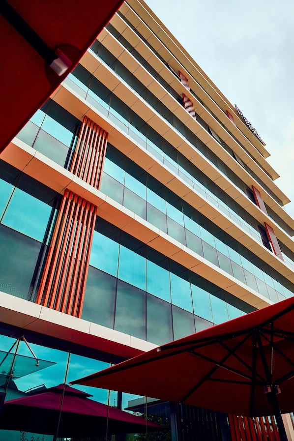 A modern hotel with multiple floors, large windows, and a prominent red and beige color scheme. - The Plaza Hotel Edirne (Edirne)