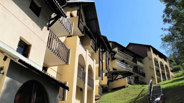 A multi-story building with balconies and a staircase leading up a grassy slope. - 300m from ski slopes, 1st floor, balcony, 24m², Vars (Vars)