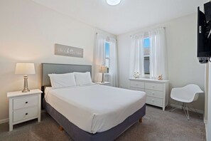 - Elegant bedroom featuring a plush queen-size bed and calming decor for restful nights
- Large windows with sheer curtains create a bright and cheerful atmosphere
- Spacious and well-appointed, this room is perfect for couples or solo travelers - Private Pool Oasis! 4BR Home w/ Patio near Disney (Kissimmee)