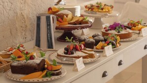 A buffet table with various desserts and fruits. - Masseria Calderisi (Fasano)