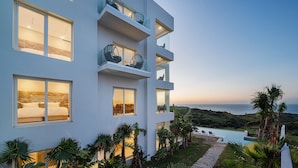 A modern multi-story building with large windows, a pool, and a view of the ocean. - Le tanger (Al Bahraoyine)