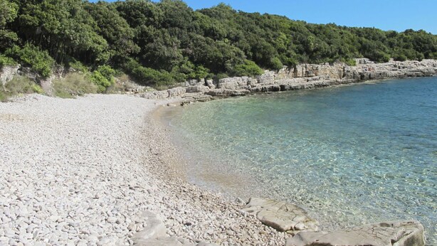 A pebble beach with clear water and rocky outcrops. - Wonderful private villa for 8 guests with A/C, private pool, WIFI, TV, patio and pets allowed (Muntic)