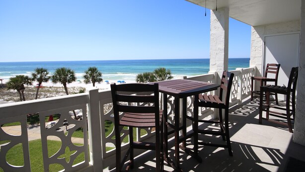 A balcony with a table and chairs overlooking a beach. - El Matador 448 -  FREE TICKETS!! Your stay includes free tickets to many area attractions! (Fort Walton Beach)