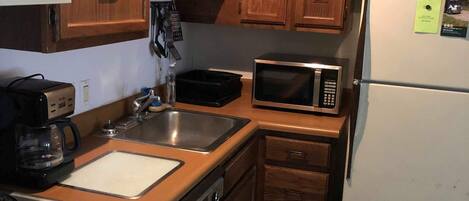 Dishwasher, coffee/tea maker, cookware/dishes/utensils