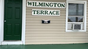 A house with a green door and a sign that reads "WILMINGTON TERRACE 107". - Wilmington Terrace (Ocean City)