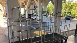 Metal carts with wheels, likely for luggage or equipment, under a covered area with concrete pillars. - Fabulous DIRECT Oceanfront, private beach, shelling & steps to beach, no traffic (Fort Myers Beach)