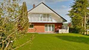 A modern house with a brick facade, large windows, and a well-maintained lawn. - Belvedere by Interhome (Manderscheid)