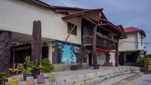A building with a rustic facade, a staircase leading to the entrance, and a sign advertising 'Sunrise Farm'.