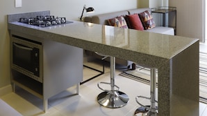 A modern kitchen with a central island, stainless steel appliances, and a built-in oven. - #1 Sophisticated Studio on Boaventura Da Silva (Fátima)