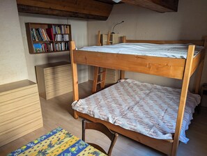 A bunk bed with a wooden headboard, a bookshelf with books, a desk with drawers, and a patterned rug. - Mas exceptional view, equipped kitchen, 2bathroom, large garden, river, parking (Roche-Saint-Secret-Béconne)