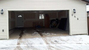 A garage with a dark roof, a white exterior, and a number '248' on the wall.