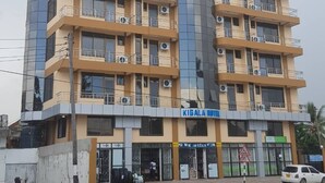 A multi-story hotel with balconies, air conditioning units, and a sign for 'Kigala Hotel'. - Kigala Hotel (Dar es Salaam)