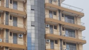 A multi-story hotel with a central glass facade and balconies on each floor. - Kigala Hotel (Dar es Salaam)