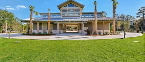 A modern building with a flat roof, large windows, and a covered entrance area.