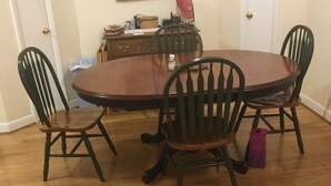 Un comedor con una mesa de madera y cuatro sillas.