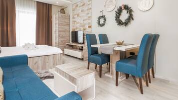 Deluxe Condo | Living area | 32-inch LCD TV with satellite channels, TV