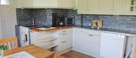 Fridge, stovetop, dishwasher, coffee/tea maker