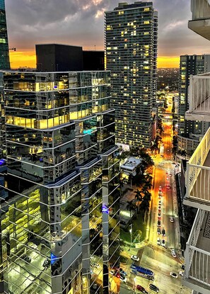 A high-rise building with multiple floors, large windows, and a busy street below.