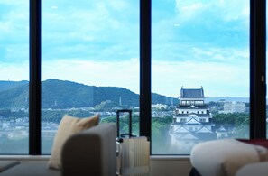 A room with a large window, a radiator, a chair, and a suitcase. - Daiwa Roynet Hotel Fukuyama Ekimae (Fukuyama)