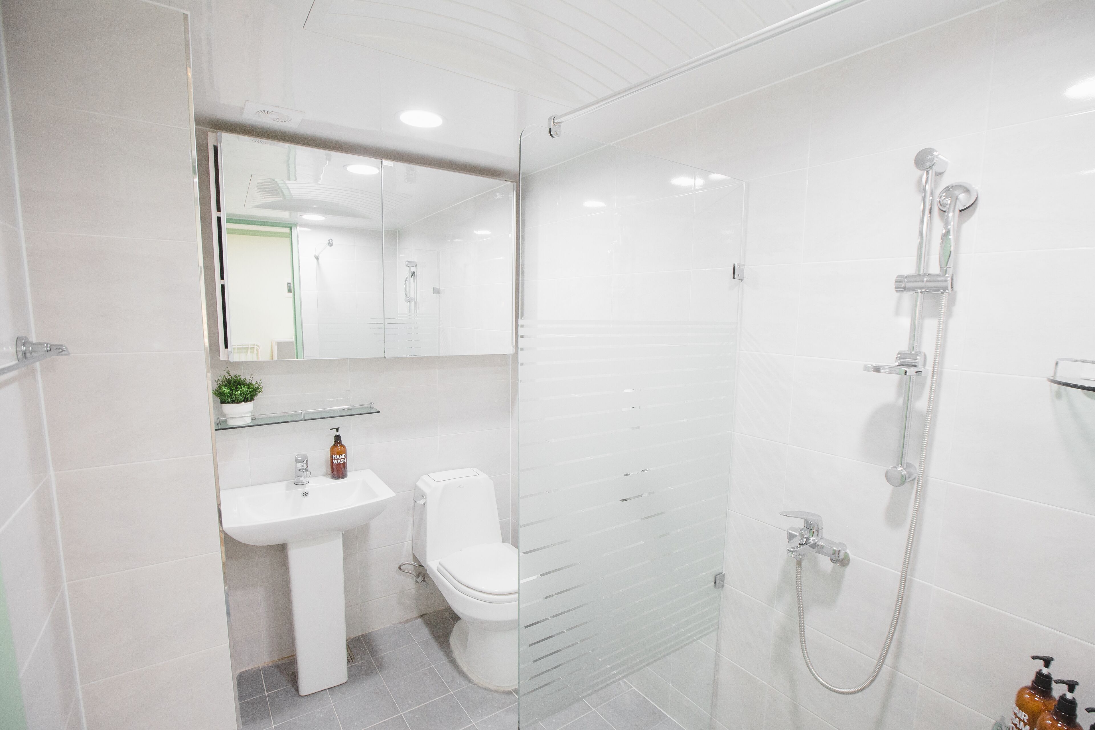 Mint House | Bathroom | Shower, free toiletries, hair dryer, slippers