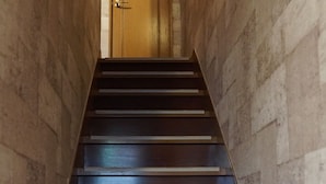 A staircase with wooden steps leading to a door at the top. - Ikken Rakutei (Tokyo)