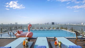 Outdoor pool, open 6:00 AM to 10:00 PM, free cabanas, pool umbrellas