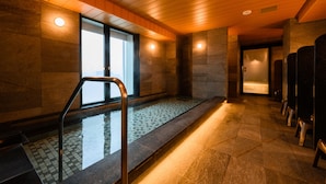 A modern indoor pool area with a tiled floor, wooden ceiling, and a glass wall. - Keikyu EX INN Haneda Innovation City (Tokyo)