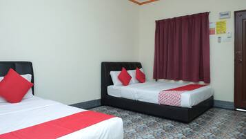 Two beds with black headboards and red accents, a tiled floor, and a door with a wall-mounted intercom.