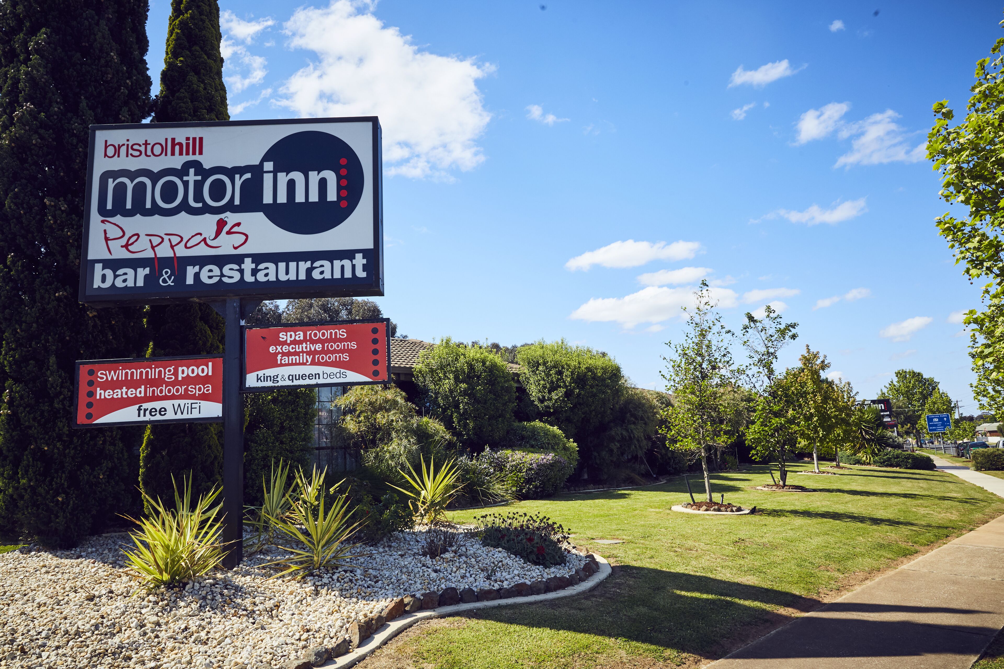 A sign for Bristol Hill Motor Inn Peppa's bar & restaurant, indicating amenities like a swimming pool, heated indoor spa, and free WiFi.