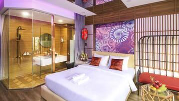 A modern hotel room with a large bed, a glass-enclosed shower, a wooden ceiling, and a decorative wall panel.