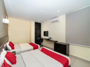 A hotel room with two beds, a desk, a chair, a television, and an air conditioning unit. - Hotel O Stay Inn (Kota Kinabalu)