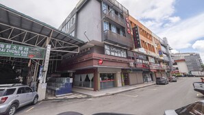 A multi-story commercial building with various storefronts, including a hotel and a restaurant. - Hotel O Blossom Hotel (Kota Kinabalu)
