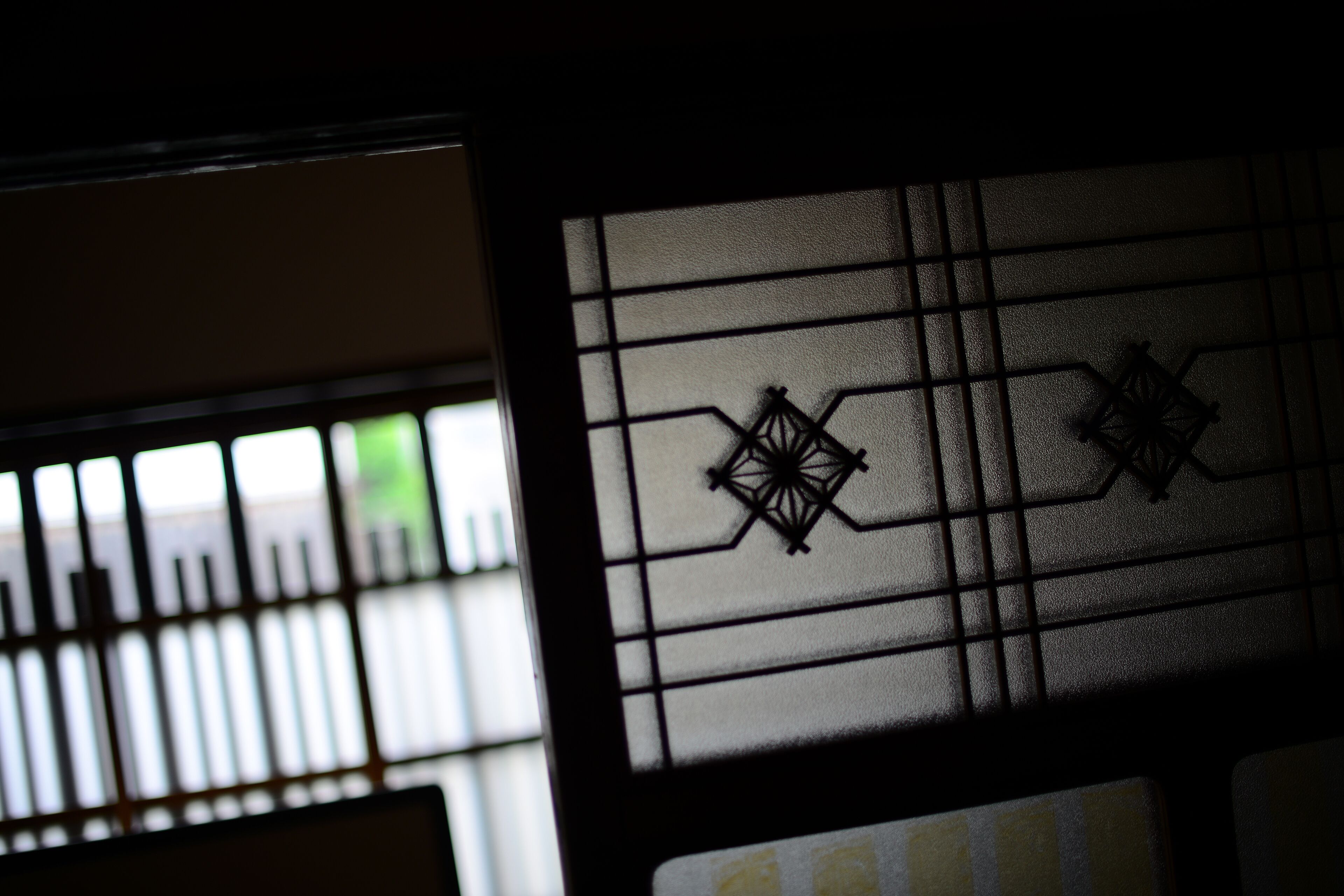 A window with a grid pattern and decorative metalwork.