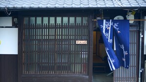 A traditional Japanese building with a wooden sliding door, a small owl figurine, and a sign reading "Fukuro." - Nishioji Fukuro (Kyoto)