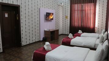 Deluxe Triple Room, 3 Bedrooms | Desk, laptop workspace, blackout drapes, soundproofing